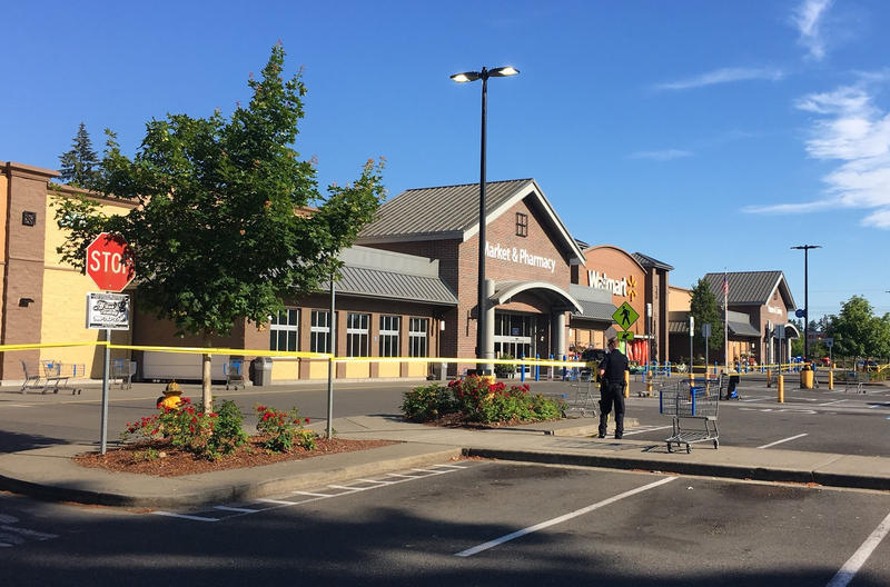 Police block the scene outside a Walmart in Tumwater where a gunman shot a driver, then was himself shot to death on Sunday afternoon.