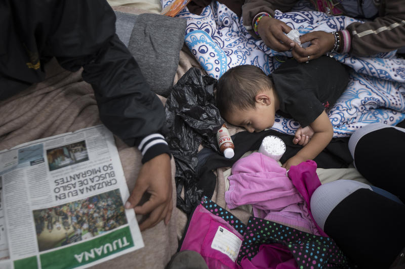 A two-year-old child from Honduras gets treatment for an ear infection after sleeping in the open in front of the El Chaparral port of entry, in Tijuana, Mexico, Monday, April 30, 2018. 