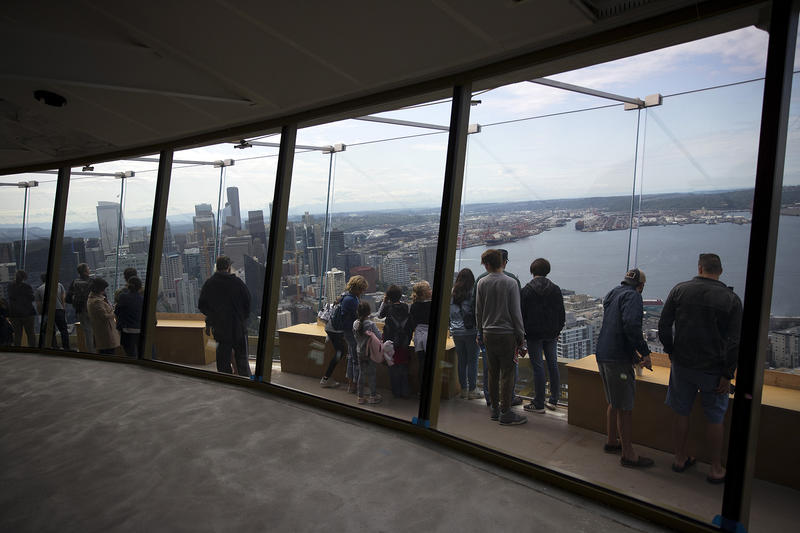 People gather on the observation deck of the Space Needle  on Tuesday, June 5, 2018, in Seattle.