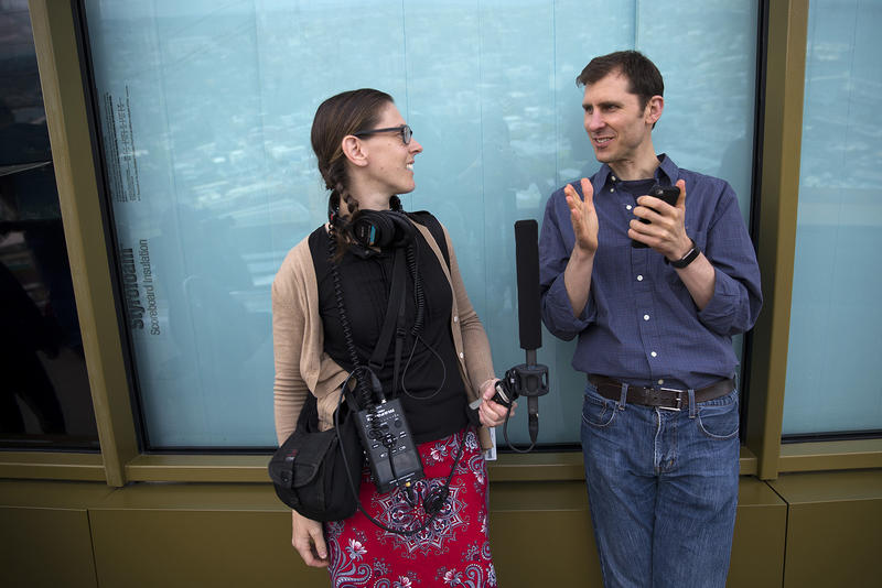 KUOW reporter Anna Boiko-Weyrauch, left, talks with KUOW listener Derek Hanson on Tuesday, June 5, 2018, on the observation deck of the Space Needle in Seattle. 