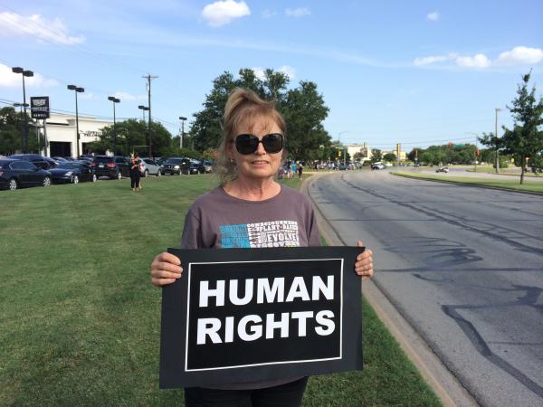 Leslie Harris of Flower Mound awaited the President's motorcade, showing her support for government assistance for detained migrant children.