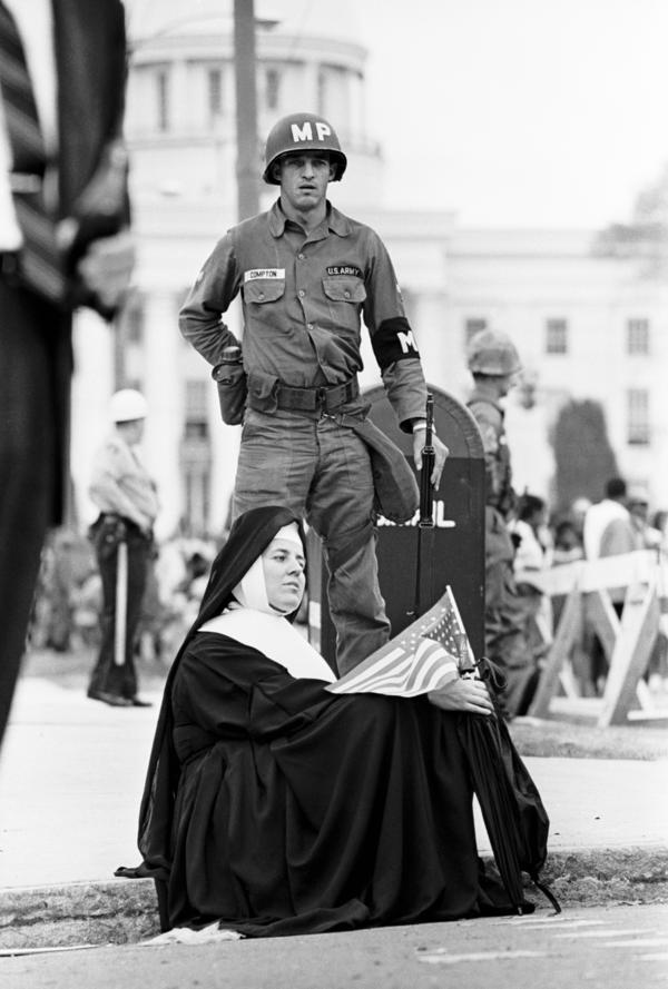 A nun and a national guardsman listen to Martin Luther King Jr. as the march ends in Montgomery.