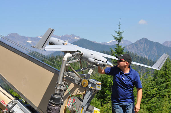 Insitu operator Joseph Cooper prepares the ScanEagle UAS for launch to surveil the Paradise Fire in Olympic National Park earlier this August.