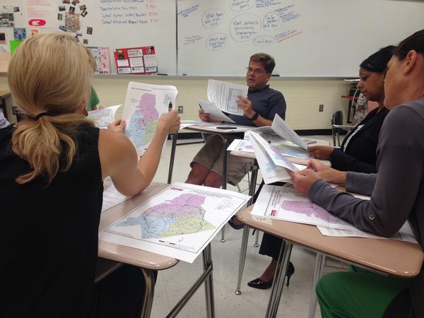 Parents at Myers Park discuss maps for proposed magnet transportation zones.