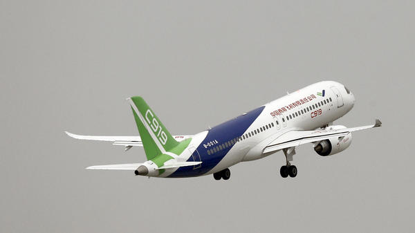 A Chinese-made C919 passenger jet takes off on its first flight at Pudong International Airport in Shanghai on Friday. It was scheduled to fly in 2014 but manufacturing problems delayed production.