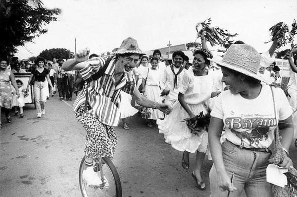 <p>Ben Linder, in a clown costume, rides his unicycle in Nicaragua.</p>
