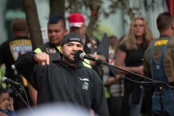 <p>Joey Gibson, the Vancouver, Washington, resident who organized Sunday's Trump Free Speech Rally in Portland addresses the crowd. Gibson held a moment of silence for the victims of the MAX train stabbings.</p>