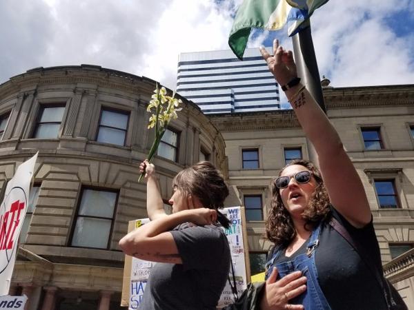 <p>Protesters sing "No hate, no fear. Immigrants are welcome here," in front of Portland City Hall.</p>