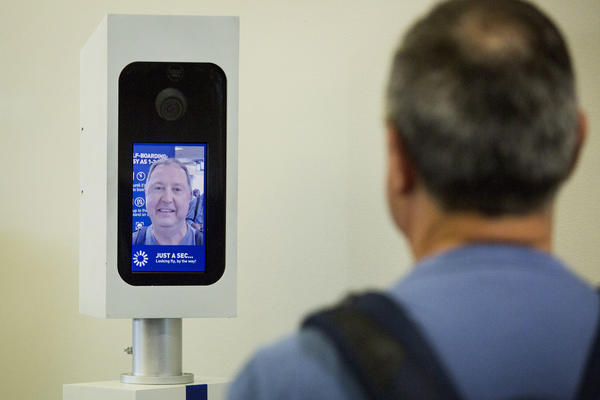Charles Camiel looks into the camera for a facial recognition test before boarding his JetBlue flight to Aruba at Logan International Airport in Boston.