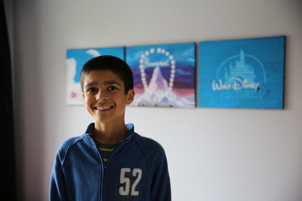 <p>Kaliq Chapin, age 12, in his room in front of Disney posters. "Monsters, Inc." is one of his favorites movies.</p>