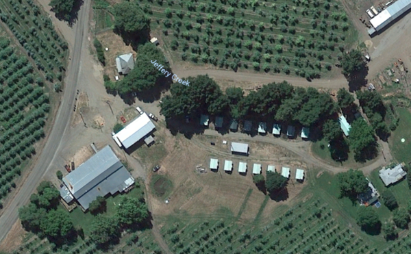 <p>Farmworker camp near Talent, Oregon.&nbsp; Rows of bunkhouse stand within 100 feet of surrounding orchards where trees are sprayed.</p>