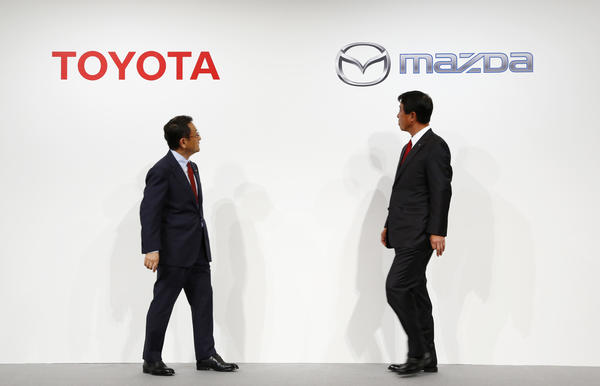 Toyota Motor Corp. President Akio Toyoda, left, and Mazda Motor Corp. President Masamichi Kogai. The rivals will build a joint manufacturing plant in Alabama. 