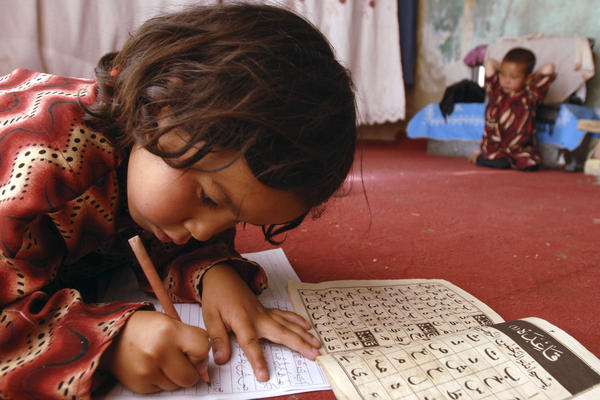 Laila, 7, works on homework in her home in Kabul, 2008.