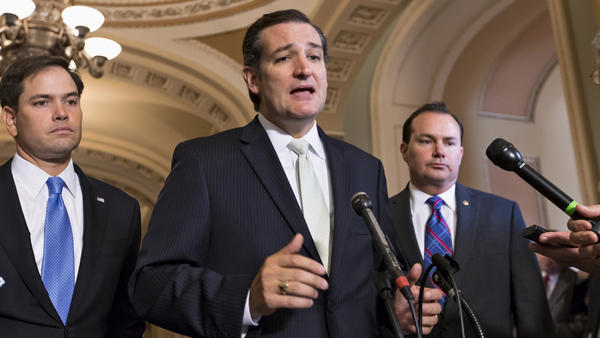 Sen. Ted Cruz, R-Texas, center, Sen. Marco Rubio, R-Fla., left, and Sen. Mike Lee, R-Utah, express frustration on Friday after the Senate passed a bill to fund the government, but stripped it of language crafted by House Republicans to defund Obamacare.