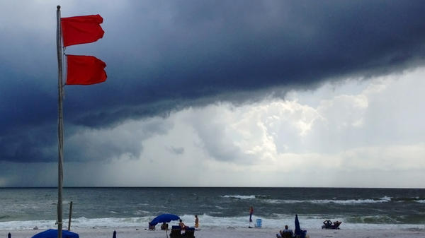 Red flags warn swimmers to stay out of the Gulf of Mexico at Gulf Shores, Ala., on Saturday.
