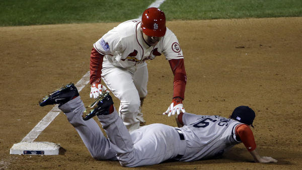 The Cardinals' Allen Craig gets tangled with Red Sox's Will Middlebrooks in the ninth. Middlebrooks was called for obstruction and Craig went in to score the game-winning run.