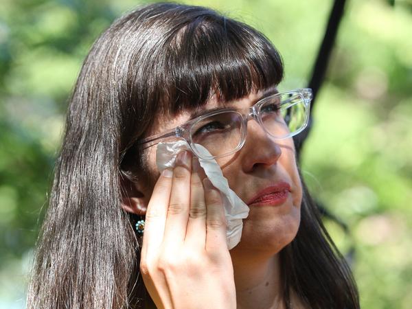 Kate Kelly, a Mormon and founder of Ordain Women, wipes away a tear during a vigil on Sunday in Salt Lake City. Church leaders have ruled to excommunicate her for advocating in favor of female priests.
