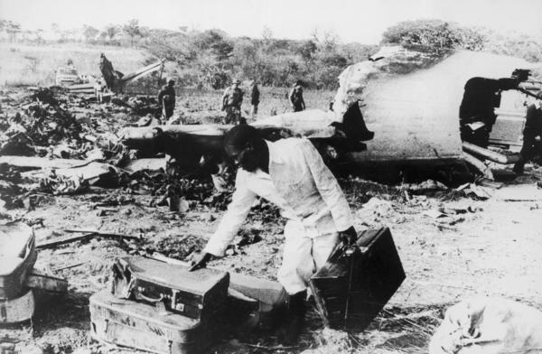 Men sift through the wreckage of an Air Rhodesia plane shot down by guerrilla fighters in September 1978 in northern Rhodesia (now Zimbabwe). The rebels shot down another Air Rhodesia flight five months later.