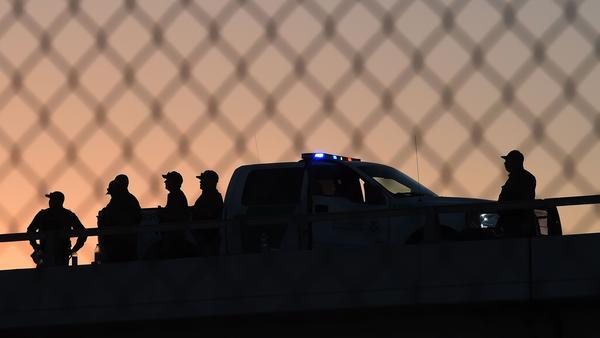 U.S. Border Patrol officers keep watch at the fence separating U.S. and Mexico in the town of El Paso, Texas.