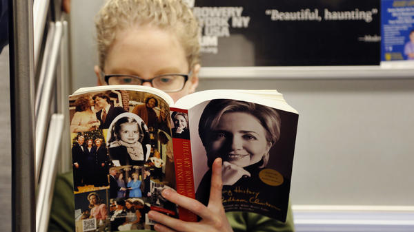 Linda Leseman reads Hillary Clinton's memoir, <em>Living History</em>, while riding the New York City subway Tuesday.