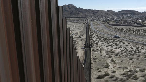 A truck drives near the Mexico-U.S. border fence, on the Mexican side, separating the towns of Anapra, Mexico, and Sunland Park, N.M., Wednesday.