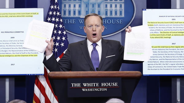 Trying to prove a point that little has changed, White House press secretary Sean Spicer holds up highlighted papers about the National Security Council. But that's not quite true.