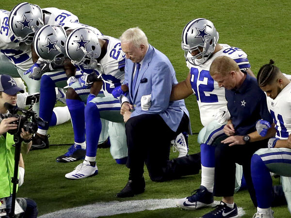 On Sept. 25, the Dallas Cowboys, led by owner Jerry Jones (center), took a knee prior to the national anthem before an NFL football game against the Arizona Cardinals, in Glendale, Ariz. Now he says players who "disrespect the flag" won't play.