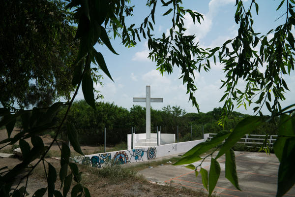 A cross erected just feet from the Rio Grande border and several of the bridges between Matamoros, Mexico, and Brownsville, Texas, is a popular stop where migrants pray before the final steps of their journey to the U.S.