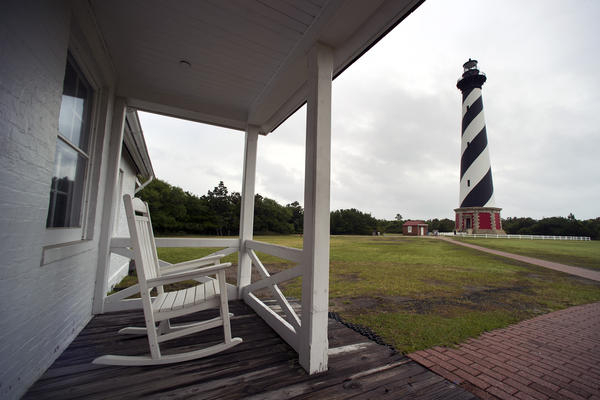 The Cape Hatteras Lighthouse seen from the light keepers house in Buxton. The lighthouse was put in service in 1870 and is the world's tallest brick lighthouse at 208 feet. Its beacon can be seen 20 miles out at sea.