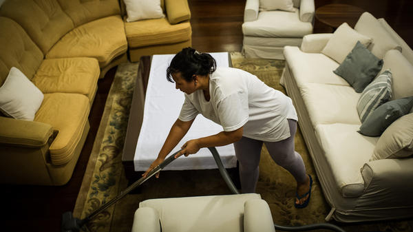 Cassia Mendes, who has worked as a housekeeper for more than 20 years, cleans a house in Sao Paulo, Brazil, on Feb. 19, 2012. Brazil enacted on April 2 a constitutional amendment to grant domestic workers health insurance and other benefits.