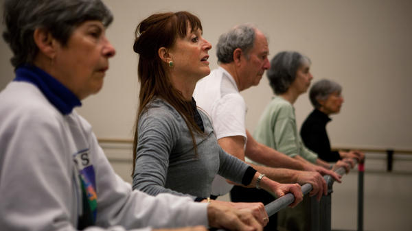 Dance teacher Lucy Bowen McCauley (second from left) finds that simply humming can help her students with Parkinson's get their feet to "unfreeze" and match the song's rhythm.