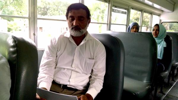 Hafiz Sibtain reviews a sample ballot as he rides a bus to early voting in Nashville.