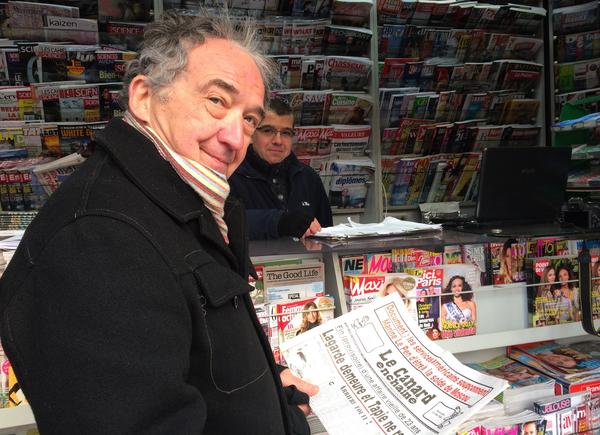 Frenchman Jean Yves Boyer buys a copy of the French weekly <em>Le Canard Enchainé,</em> which marks its 100th anniversary this year. It sells 400,000 copies a week and is profitable, though it has no advertising and just a bare-bones webpage.
