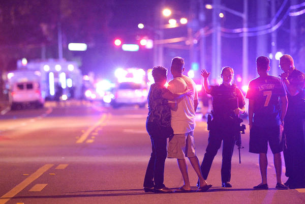 Orlando Police officers direct family members away from a fatal shooting at Pulse Orlando nightclub in Orlando, Fla., in June.