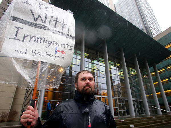 Patrick Wicklund, from Seattle, stands outside the U.S. District Court, Western Washington, on Feb. 3 in Seattle. Washington state Attorney General Bob Ferguson filed a state lawsuit challenging key sections of President Trump's immigration executive order as illegal and unconstitutional.