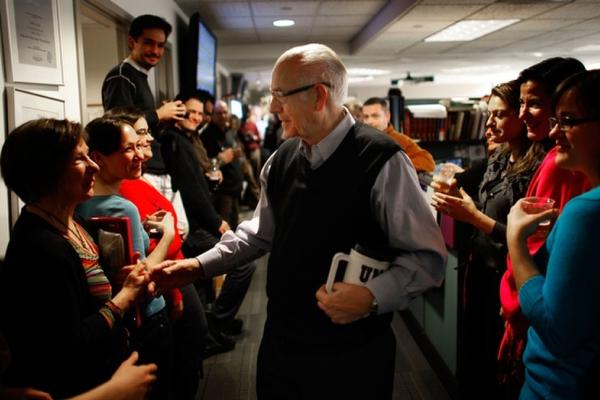 NPR employees line the hallway of the <em>Morning Edition</em> newsroom to cheer for Kasell. He was feted with speeches, champagne and cake following his final 11 a.m. newscast.