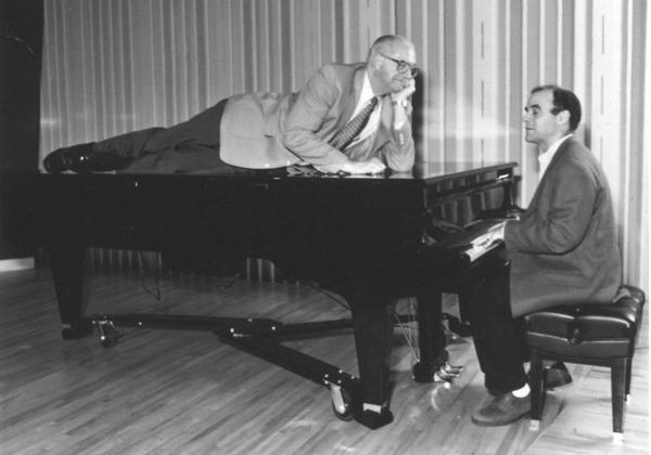 Kasell decides to take a publicity photo shoot up a notch while <em>Wait Wait... Don't Tell Me! </em>host Peter Sagal tickles the ivories.
