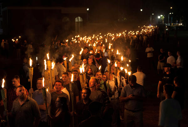 White nationalists carry torches on the eve of a Unite The Right rally in Charlottesville, Va., on Aug. 11.