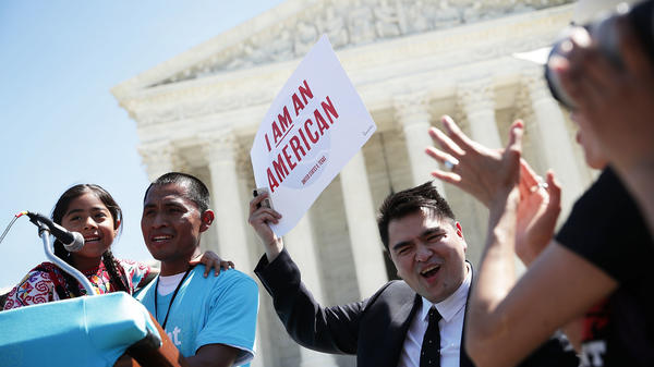 Six-year-old Sophie Cruz speaks during a rally in front of the Supreme Court next to her father, Raul Cruz, and supporter Jose Antonio Vargas in 2016.