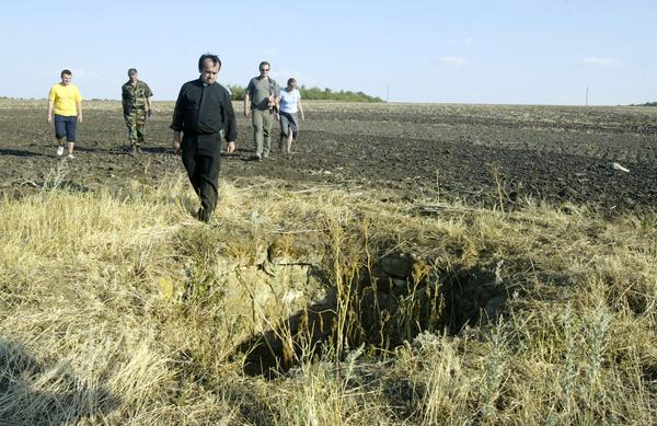 Desbois and members of his team walk to what used to be a well in Bogdanovka, Ukraine, in 2007. During the Holocaust, many Jews were thrown into the well dead or still alive. Over a period of three weeks in late December 1941 and early January 1942 — with a break for Christmas — 48,000 Jews were executed in Bogdanovka.