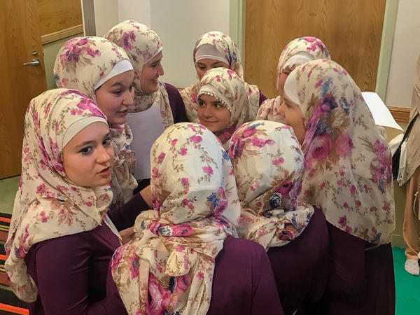 A girls' choir at the Bosnian Islamic Cultural Center in Chicago gather after performing for the congregation.