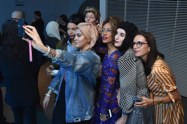 Amani Al-Khatahtbeh (center, holding camera), founder of MuslimGirl, and Elaine Welteroth (center, in glasses), former editor-in-chief of <em>Teen Vogue</em>, join a group selfie at National Geographic's premiere screening of <em>America Inside out with Katie Couric</em> in April in New York City.