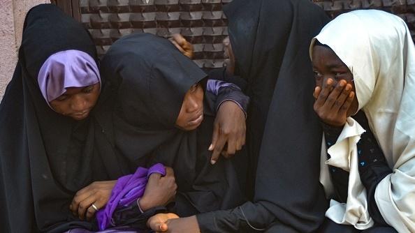 mourners attend the burial of people killed in violent clashes