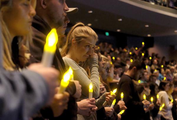 People gather to pray for the victims of a mass shooting during a candlelight vigil in Thousand Oaks, Calif., Thursday, Nov. 8, 2018. A gunman opened fire Wednesday evening inside a country music bar, killing multiple people, including a responding sheriff's sergeant.