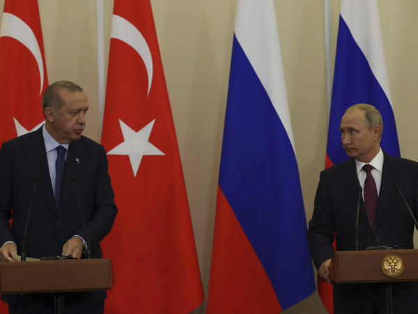 Russian President Vladimir Putin (right) listens to Turkey's President Recep Tayyip Erdogan, during a joint news conference following their meeting in Sochi, Russia, Monday. The province of Idlib in northwestern Syria is the largest bastion of the opposition, and Turkey has been eager to prevent a potential government offensive there.