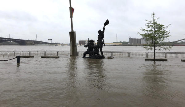 A statue of explorers Lewis and Clark is surrounded by floodwaters along the St. Louis riverfront on Thursday.