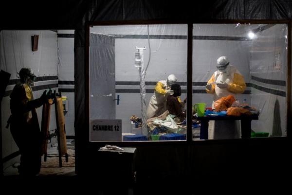 Health workers treat a patient at the Ebola Treatment Center in the city of Butembo, in the Democratic Republic of Congo. It's one of three locations where researchers have been conducting a clinical trial of four experimental treatments for the disease.