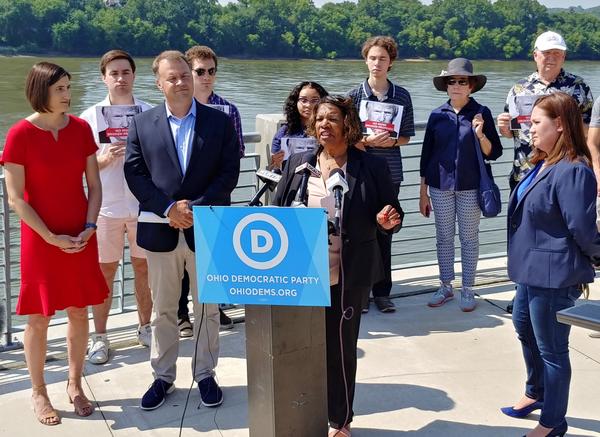 Ohio Democrats stand alongside the Ohio River hours before President Trump's rally at US Bank Arena.