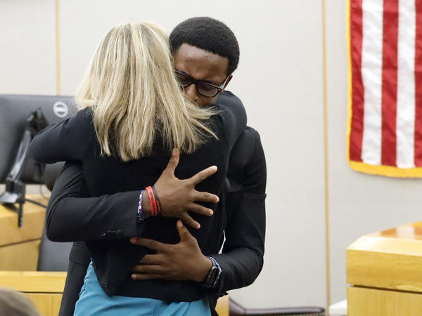 Botham Jean's younger brother, Brandt Jean, hugs former Dallas police officer Amber Guyger after delivering his victim-impact statement. Guyger was convicted for Botham Jean's murder on Tuesday and was sentenced to 10 years in prison on Wednesday.