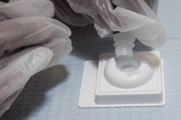 Lynn Ismael performs a rapid HIV test on a blood sample at an event in Wilton Manors in 2013. 